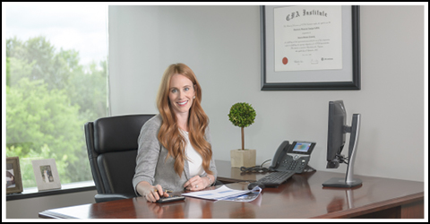 Jessica Marlow, CFA sitting at her desk.
